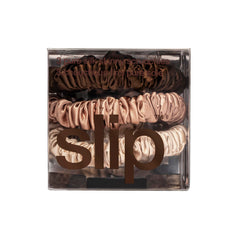 SLIP trio of silk scrunchies on white background highlighting discreet, natural tones