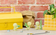Smiski next to a coin for scale showing compact collectible size
