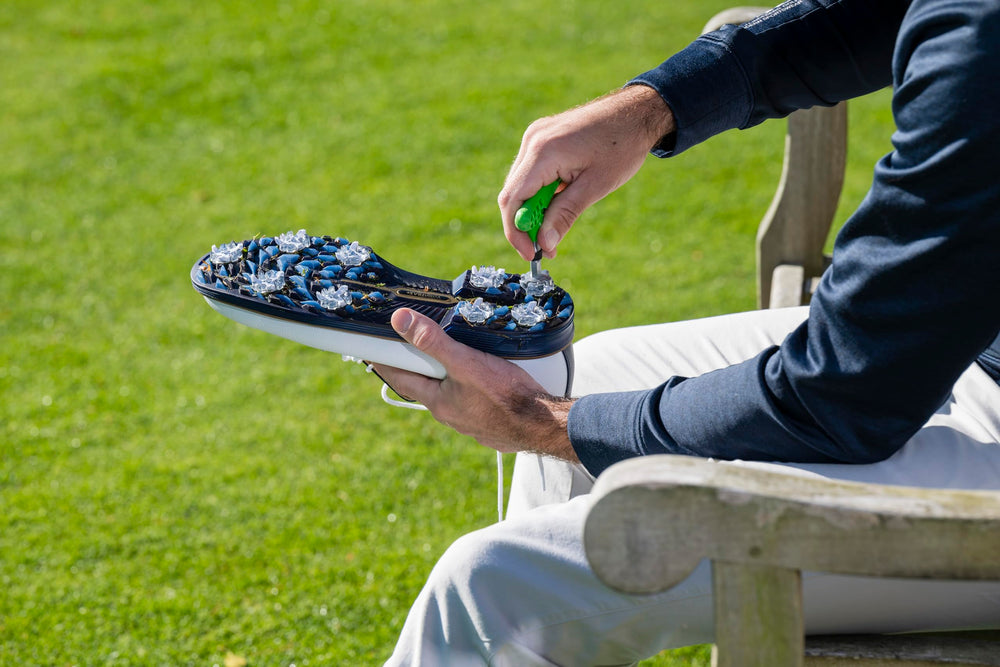 SOFTSPIKES shoe striking turf with spikes delivering consistent grip