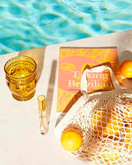 Sol de Janeiro bottle held in hand showing 8mL scale and convenient portability
