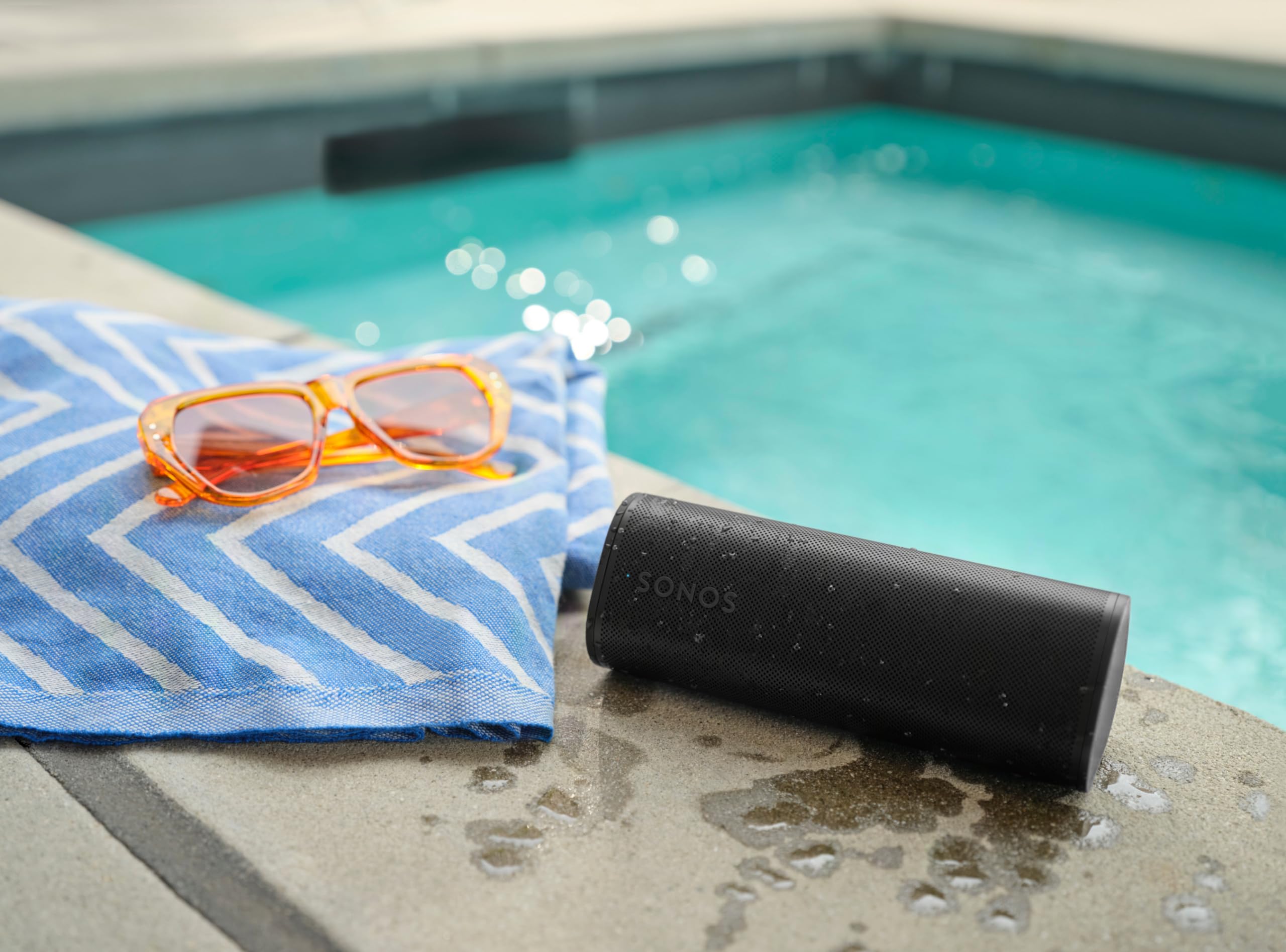 Sonos Roam 2 on compatible wireless charger with USB‑C cable, Sonos convenient charging options