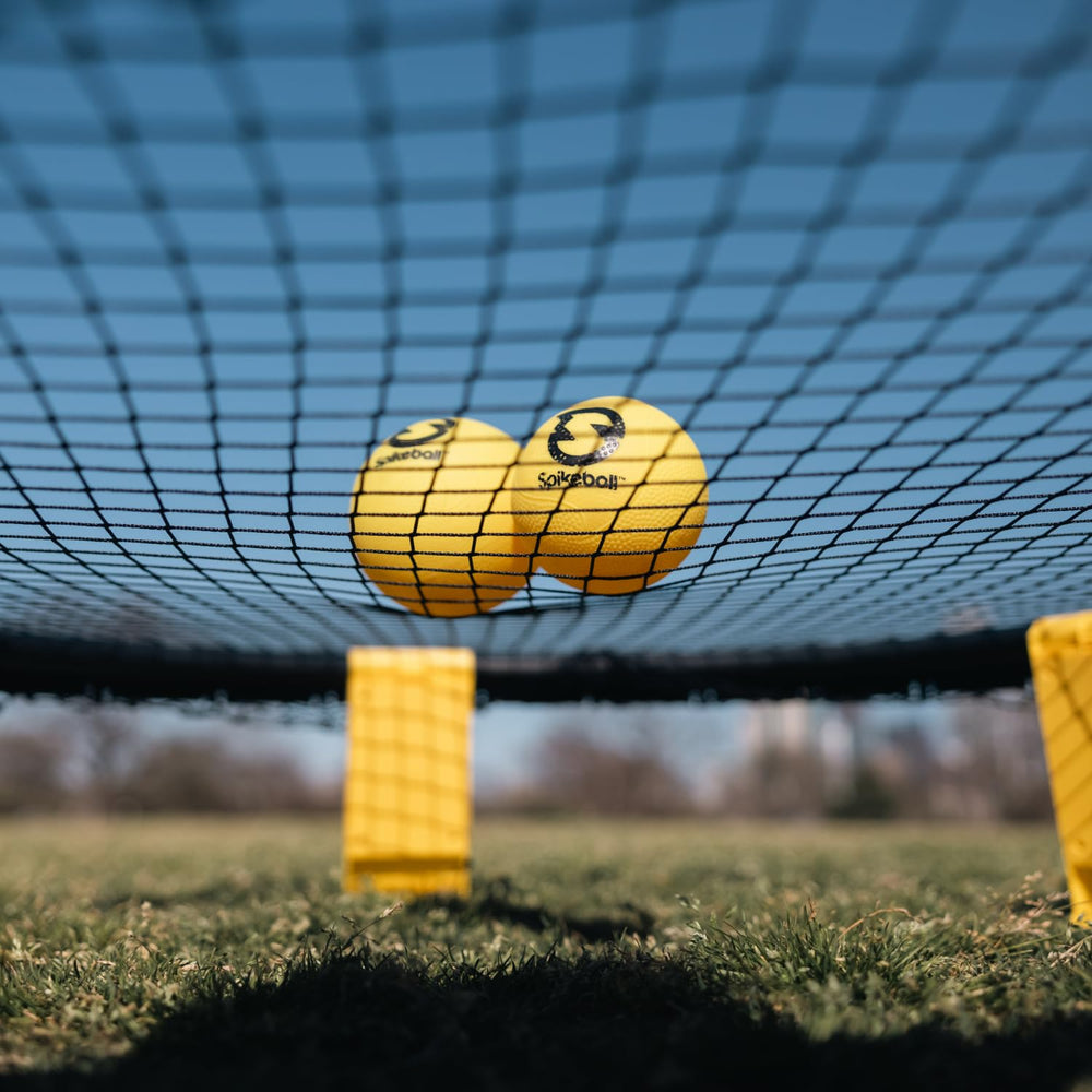 Spikeball rulebook and accessories spread, Spikeball easy learning and reference benefit