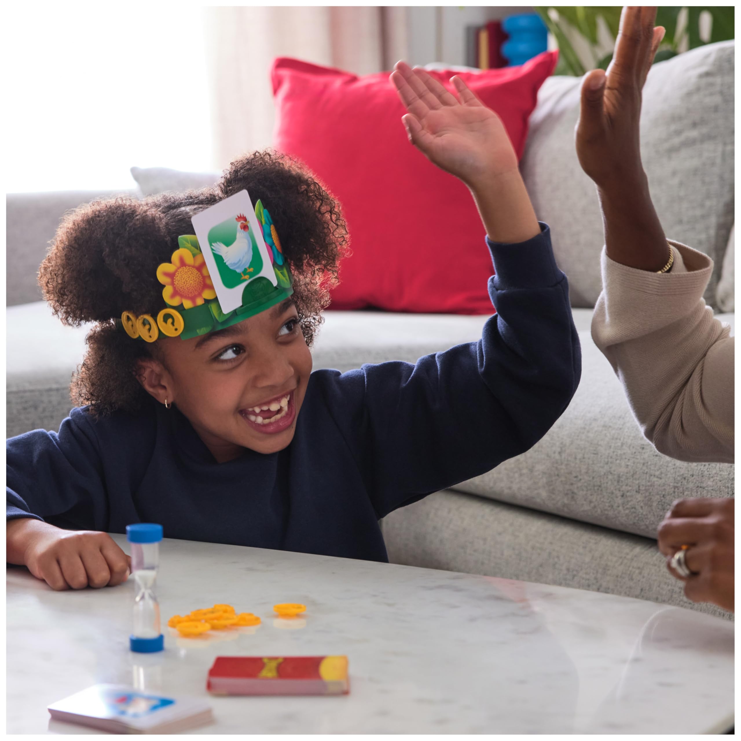 Spin Master Hedbanz child sliding a card into a headband demonstrating easy setup