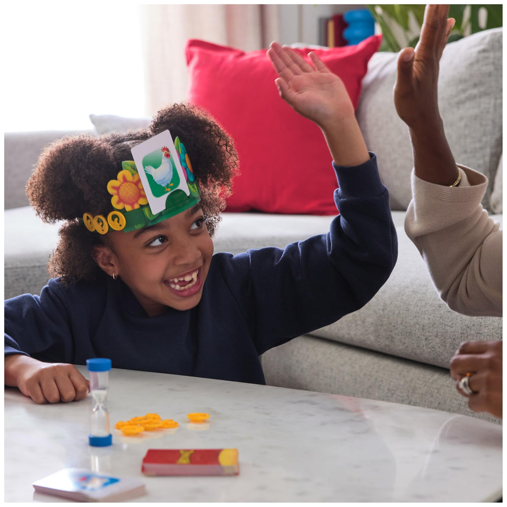 Spin Master Hedbanz child sliding a card into a headband demonstrating easy setup
