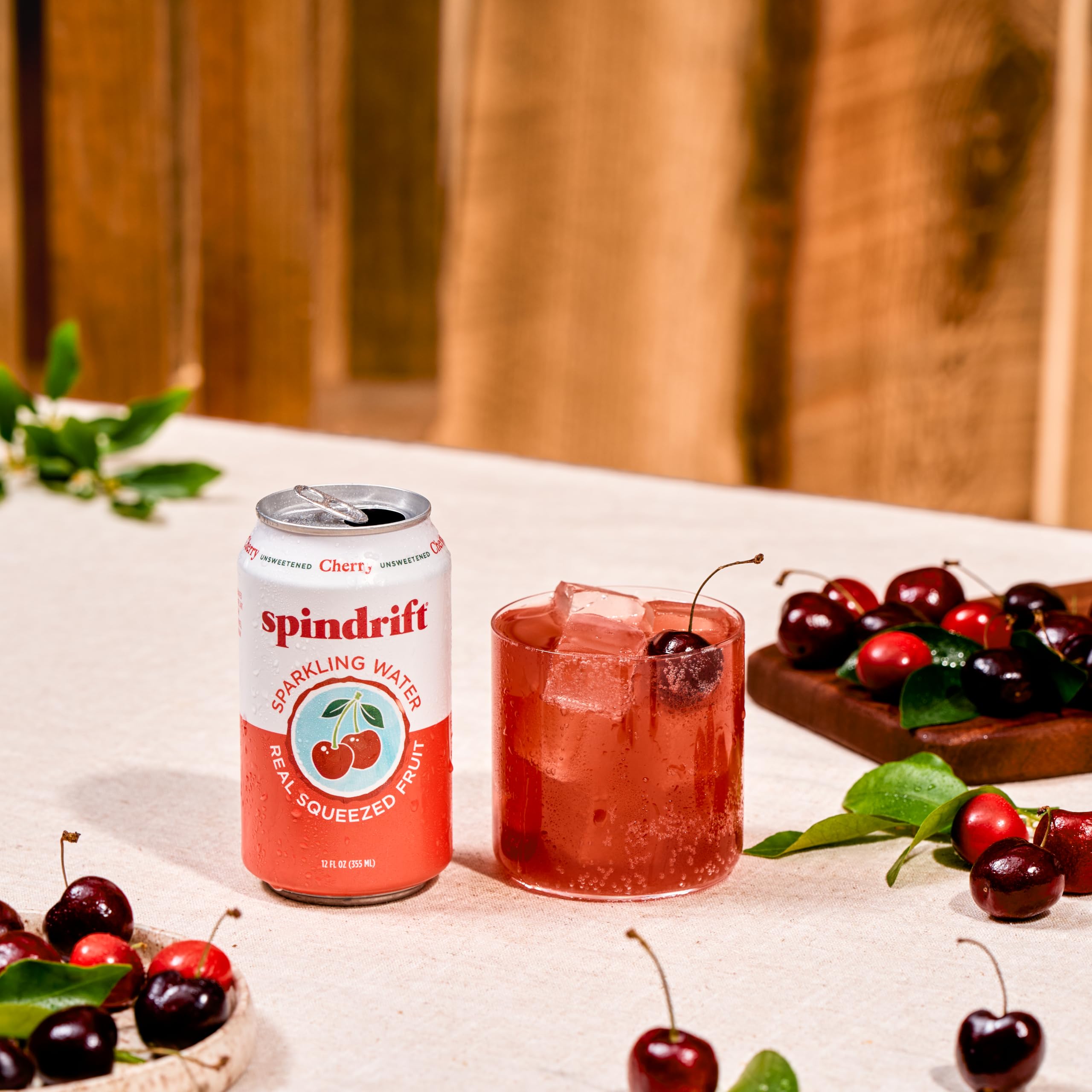 Spindrift can beside fresh cherries showing real fruit sourcing benefit