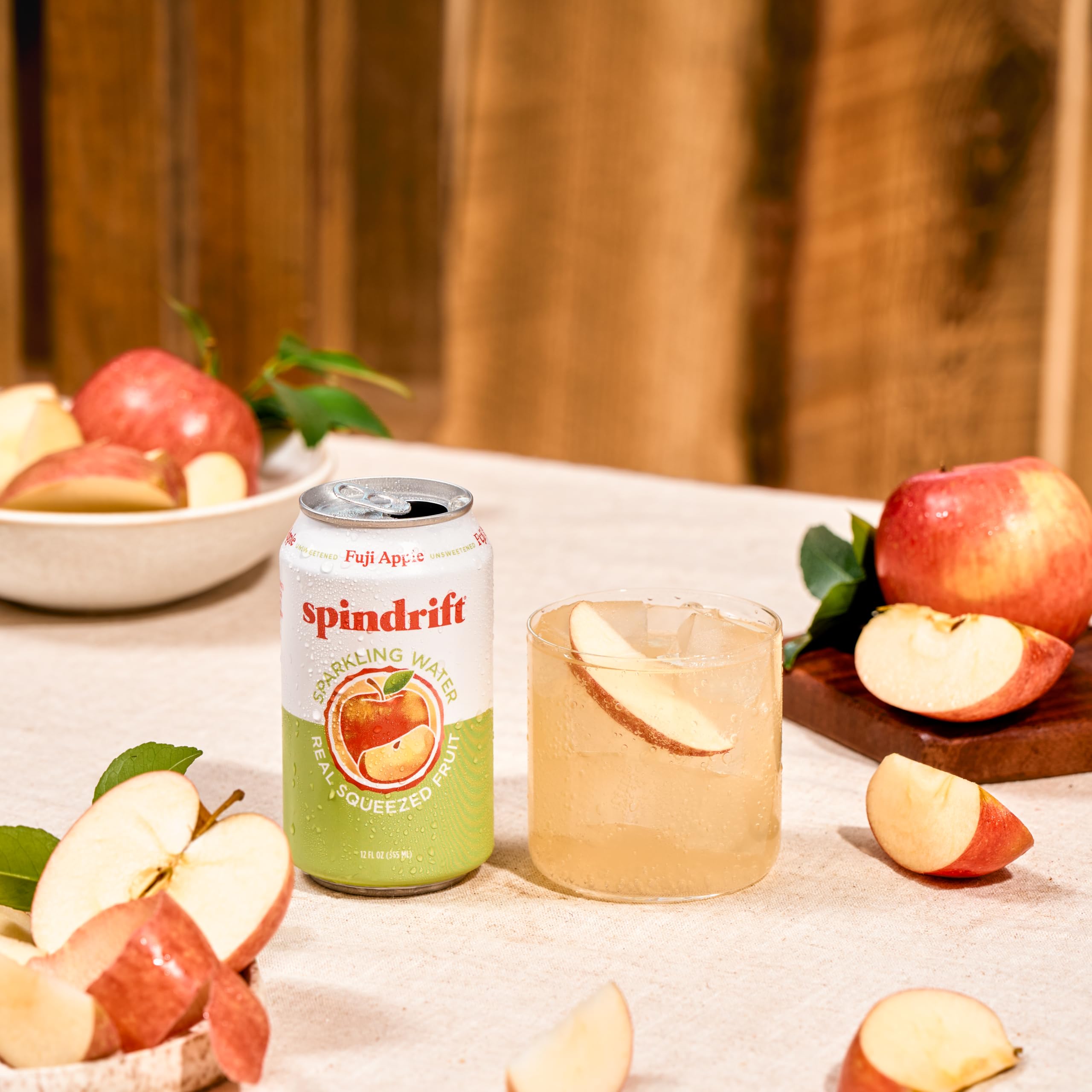 Spindrift Fuji Apple on picnic blanket with snacks suggesting social portability