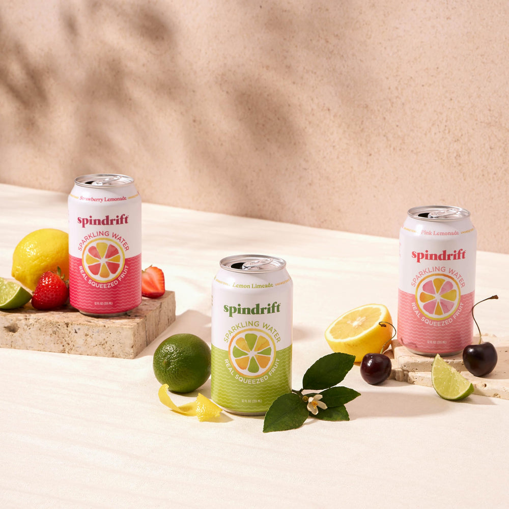 Spindrift cans at a picnic with snacks, highlighting social refreshment and portability