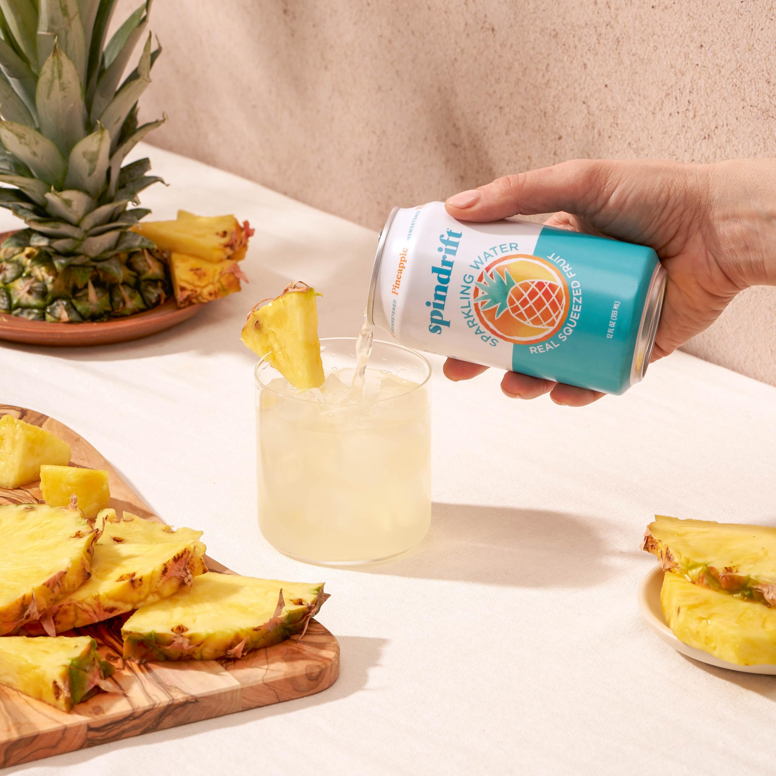 Hand holding Spindrift pineapple can for scale and portability benefit