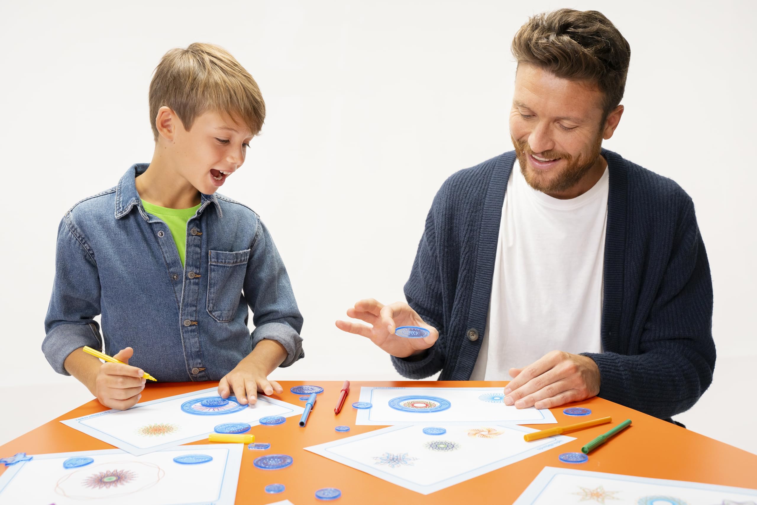 Spirograph lifestyle crafting scene with family making geometric art together