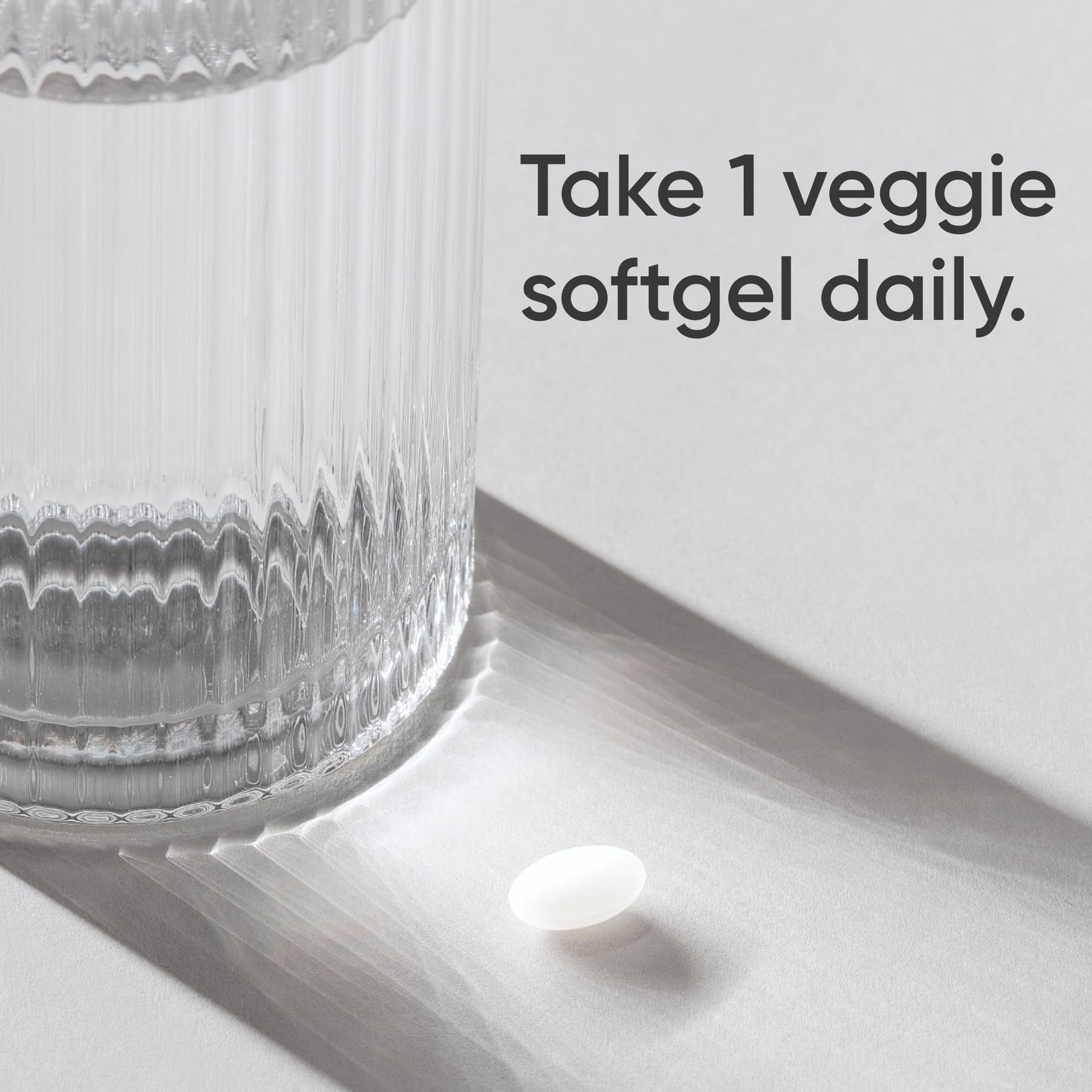 open bottle with capsules poured out illustrating easy once-daily dosing