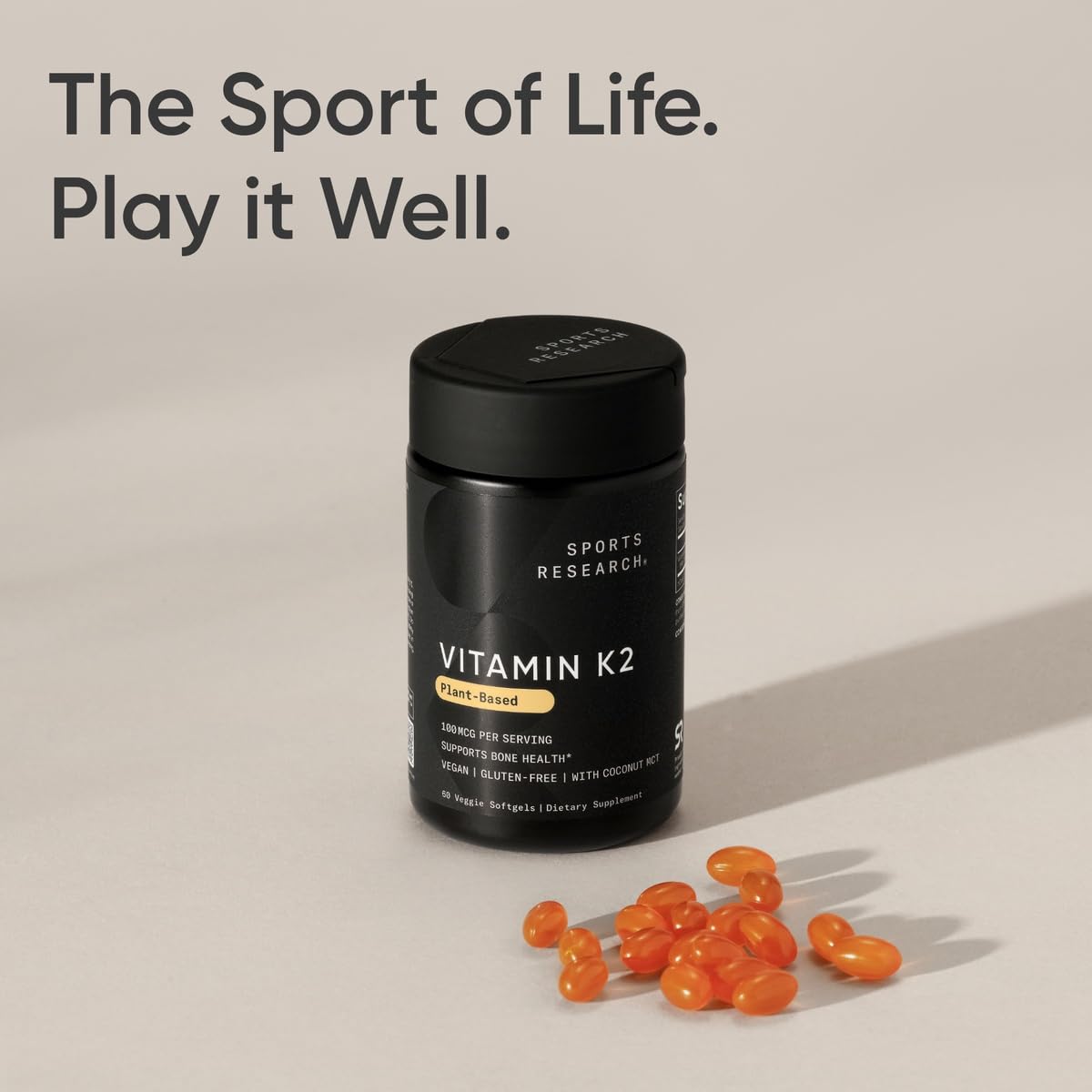 Hand holding one Sports Research softgel to demonstrate size and ease of daily one-a-day dosing
