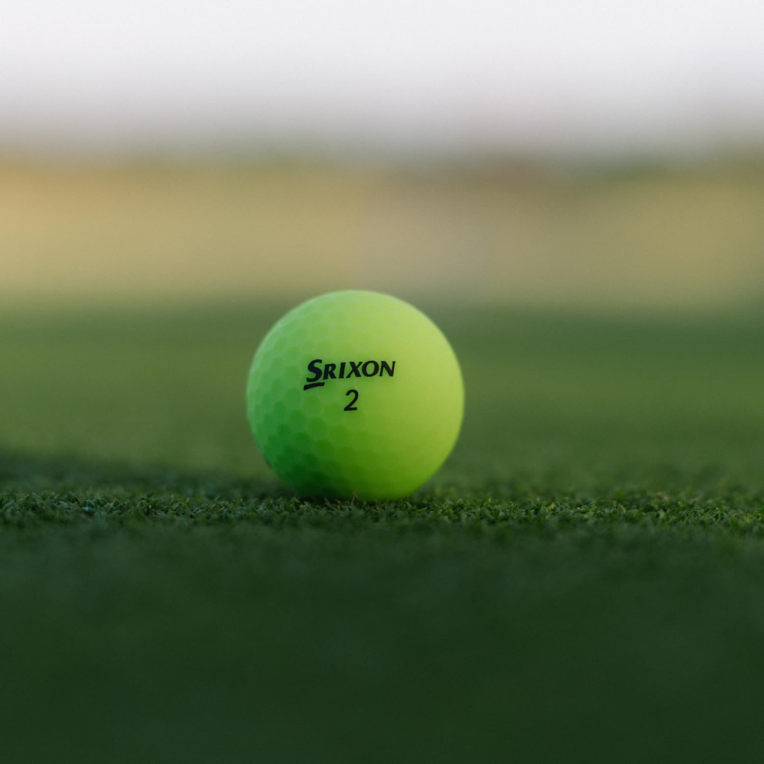 Srixon soft feel ball beside standard marker to show true size and scale