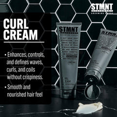 STMNT curl cream in hand applying to damp hair demonstrating simple styling step