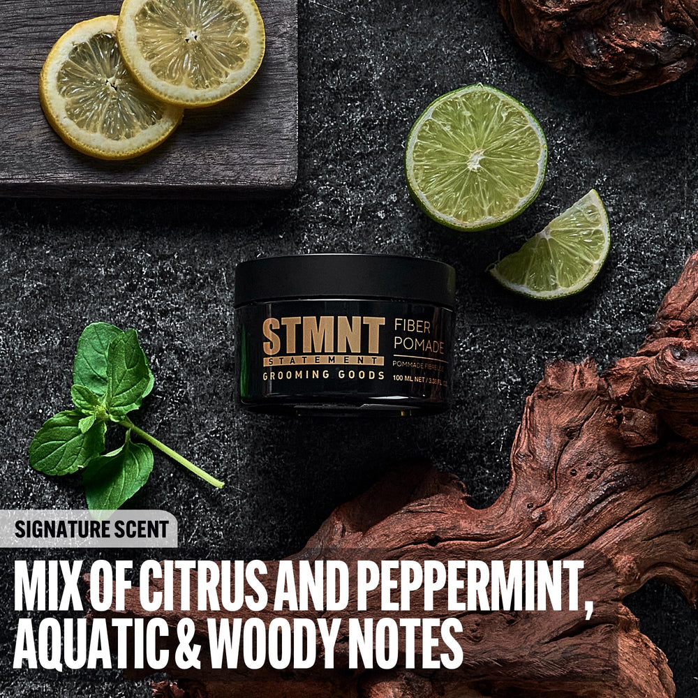STMNT open jar close‑up displaying pomade texture and elastic fibers