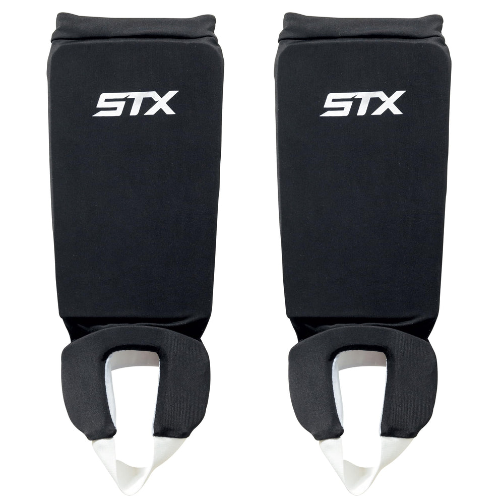 STX reversible shin shield front view showing black and white sides for quick team color change and dependable protection
