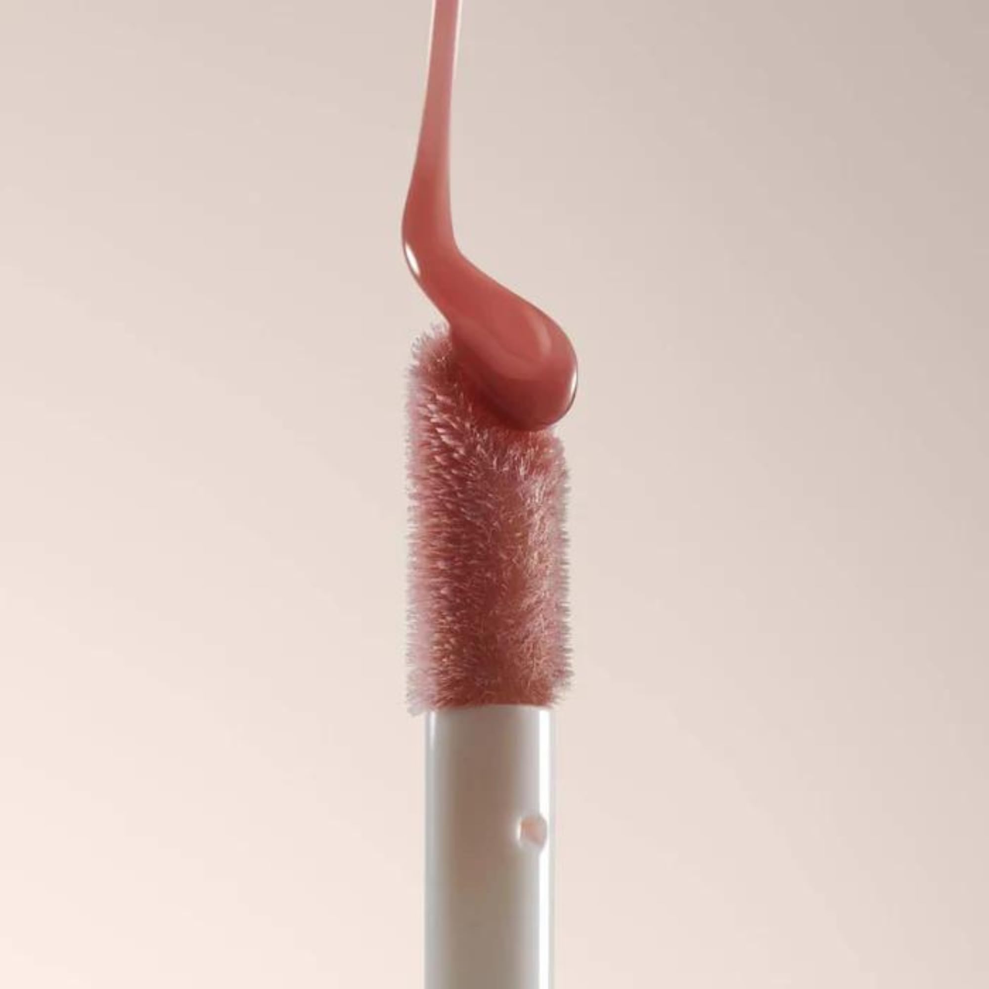 Summer Fridays layered over lipstick showing added shine and dimension benefit
