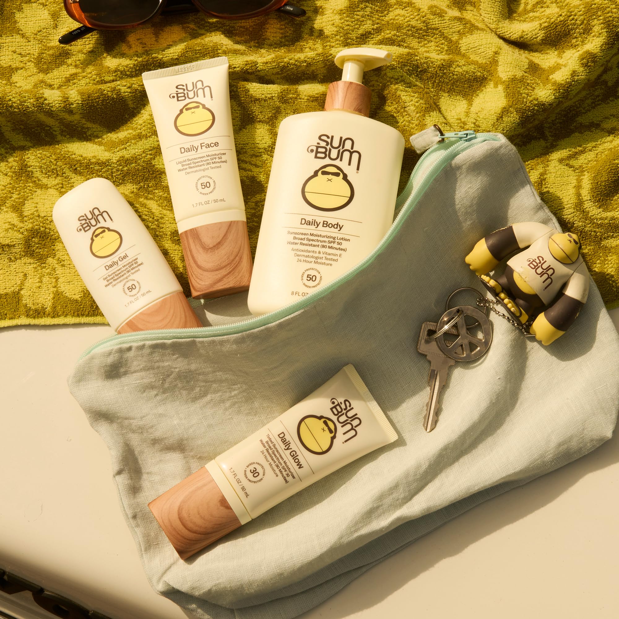 Sun Bum lotion on beach towel after swim demonstrating water resistance