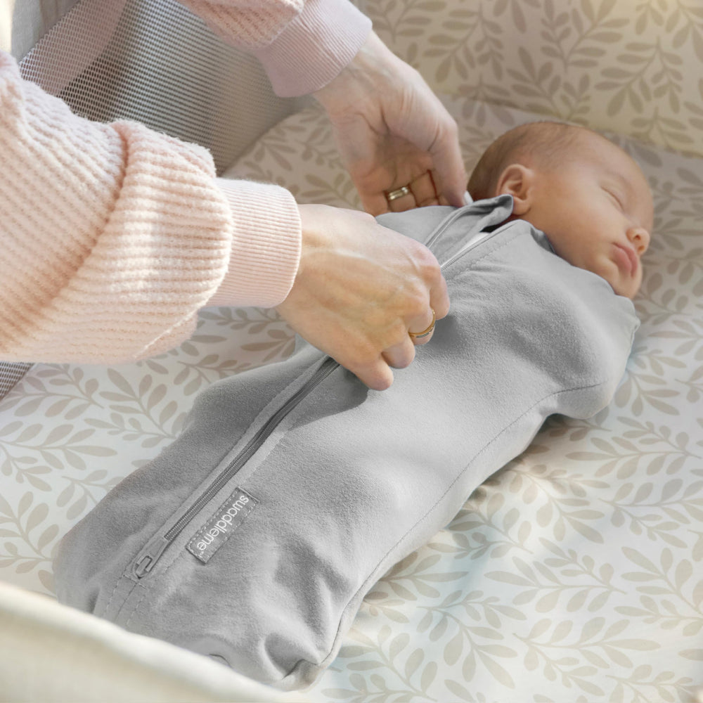 Care label photographed on SwaddleMe Little Bees pod for machine-wash instructions