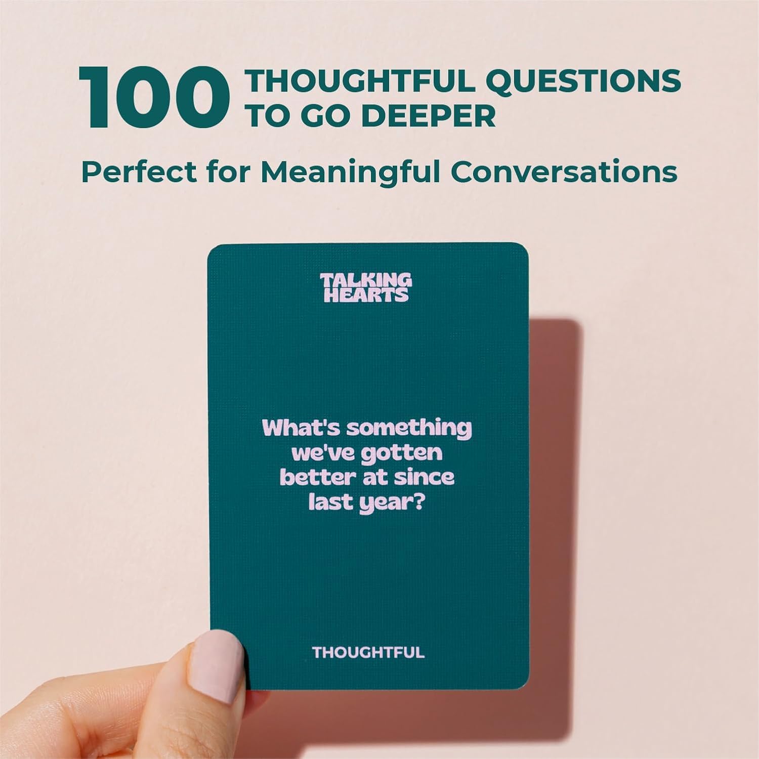 Couple using Talking Hearts cards at a candlelit table, brand encourages playful conversation