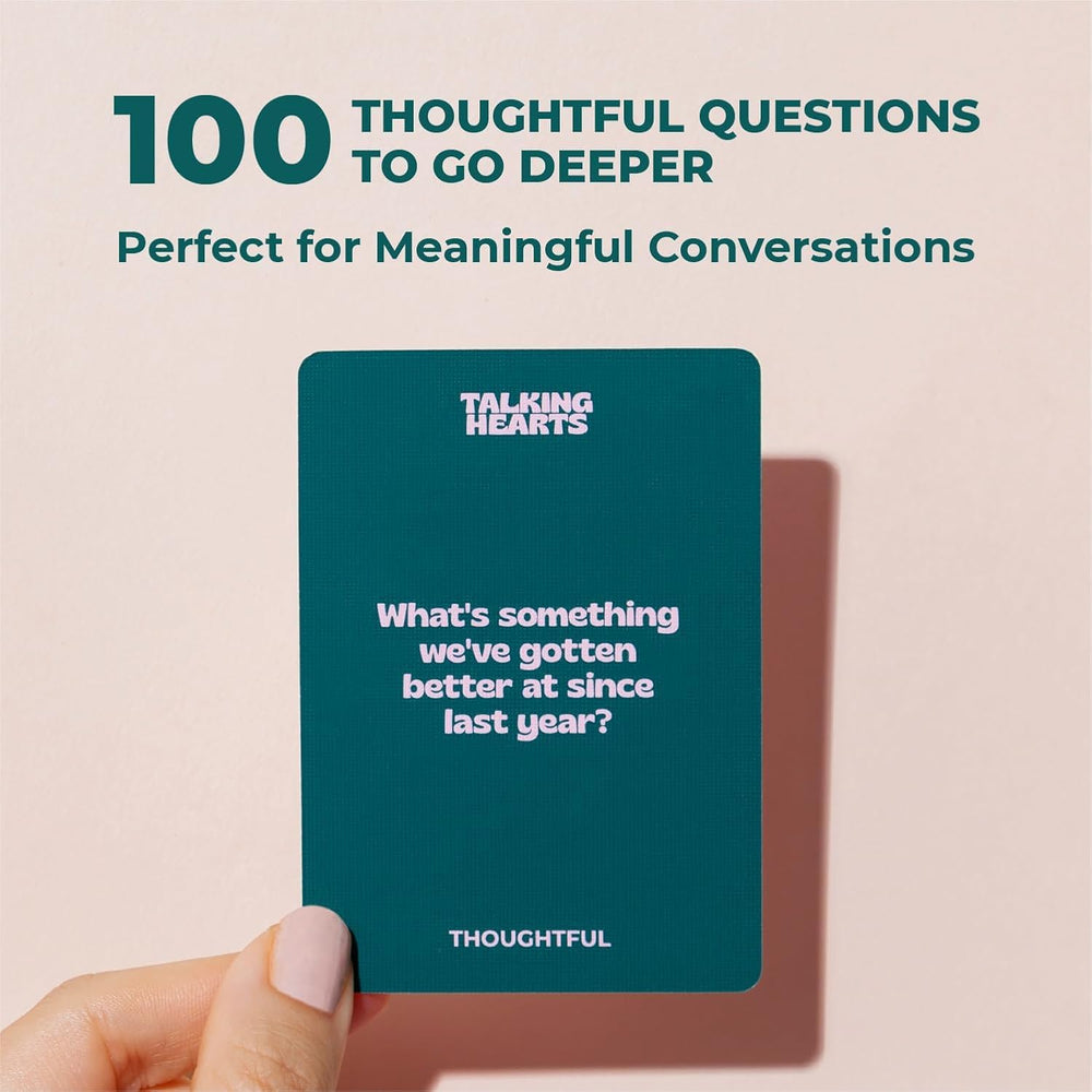 Couple using Talking Hearts cards at a candlelit table, brand encourages playful conversation