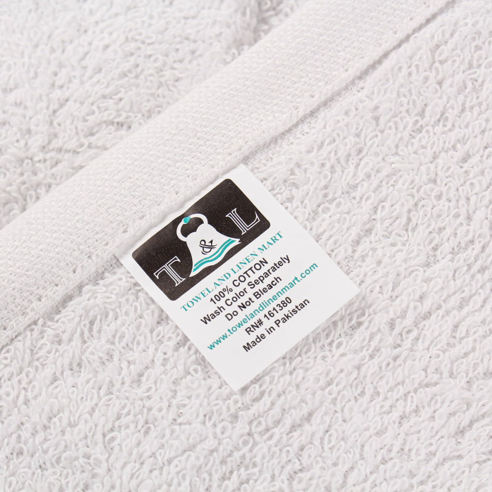 T & L Towel and Linen Mart folded towels beside a ruler demonstrating size