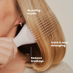 TANGLE TEEZER held in hand to show scale, portable brush for travel convenience