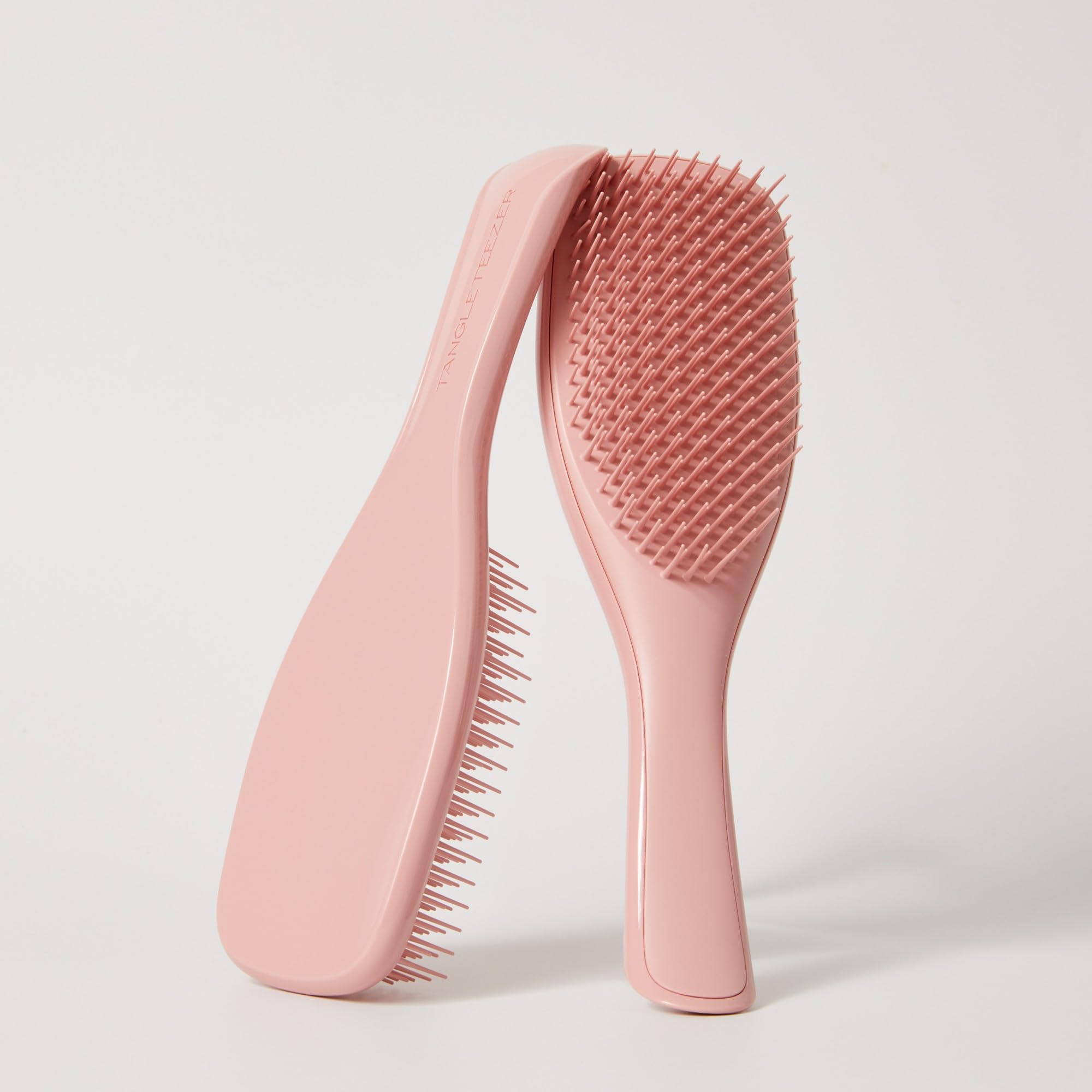 TANGLE TEEZER smoothing hair in a lifestyle shot showing frizz-control benefit
