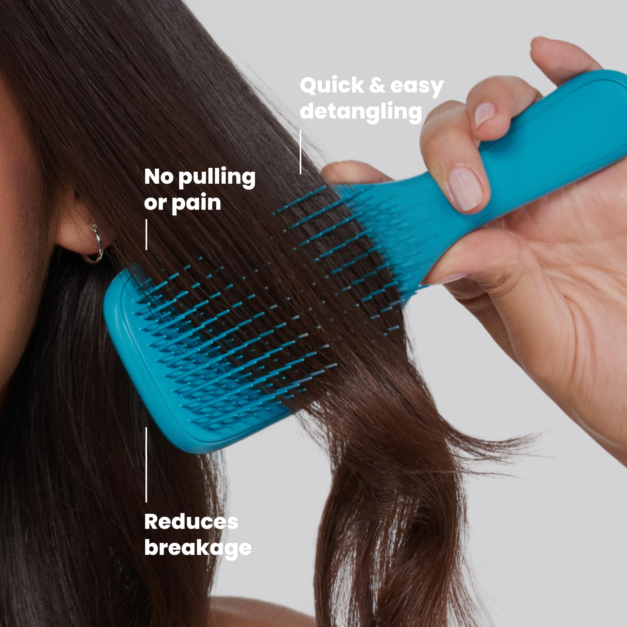 TANGLE TEEZER brush held in hand showing size and travel-friendly convenience