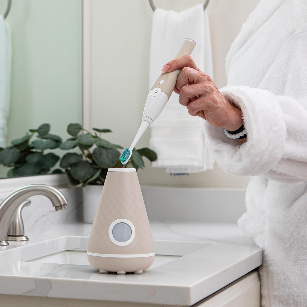 Tao Clean next to a hand for scale showing compact size and travel-friendly benefit