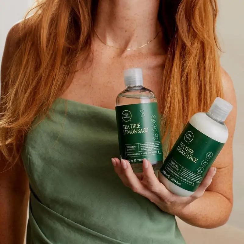 Person applying Tea Tree shampoo in shower illustrating invigorating scalp massage and volumizing action