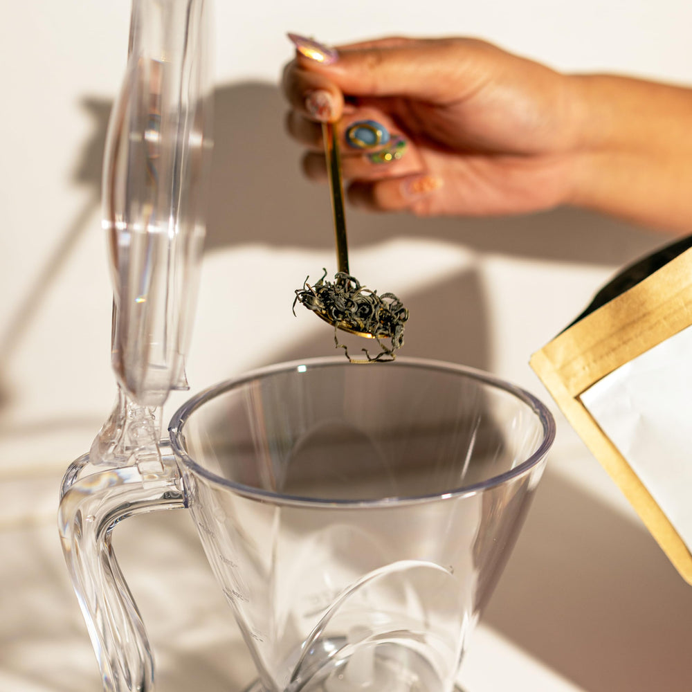 TEAZE Infuser placed over a cup releasing tea for clean pour without loose leaves