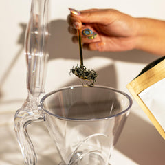 TEAZE Infuser placed over a cup releasing tea for clean pour without loose leaves