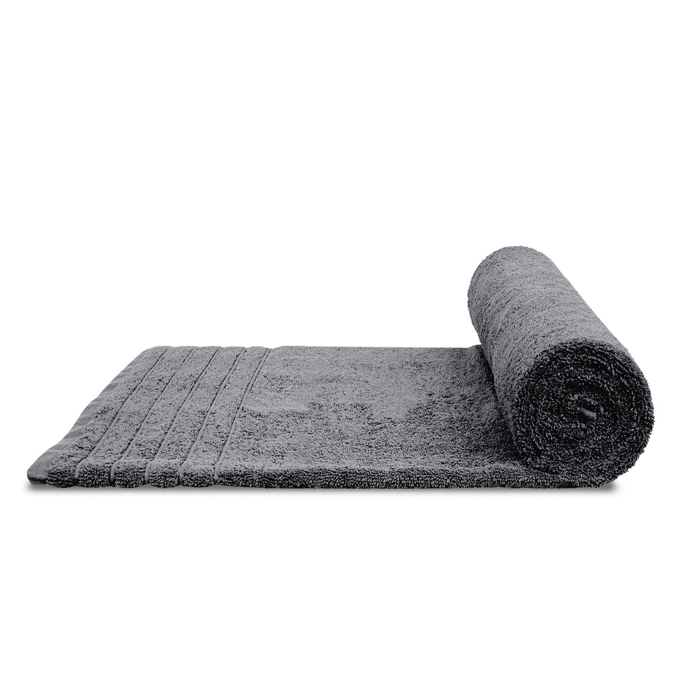 Tens Towels beside bathtub for scale and easy comparison of size