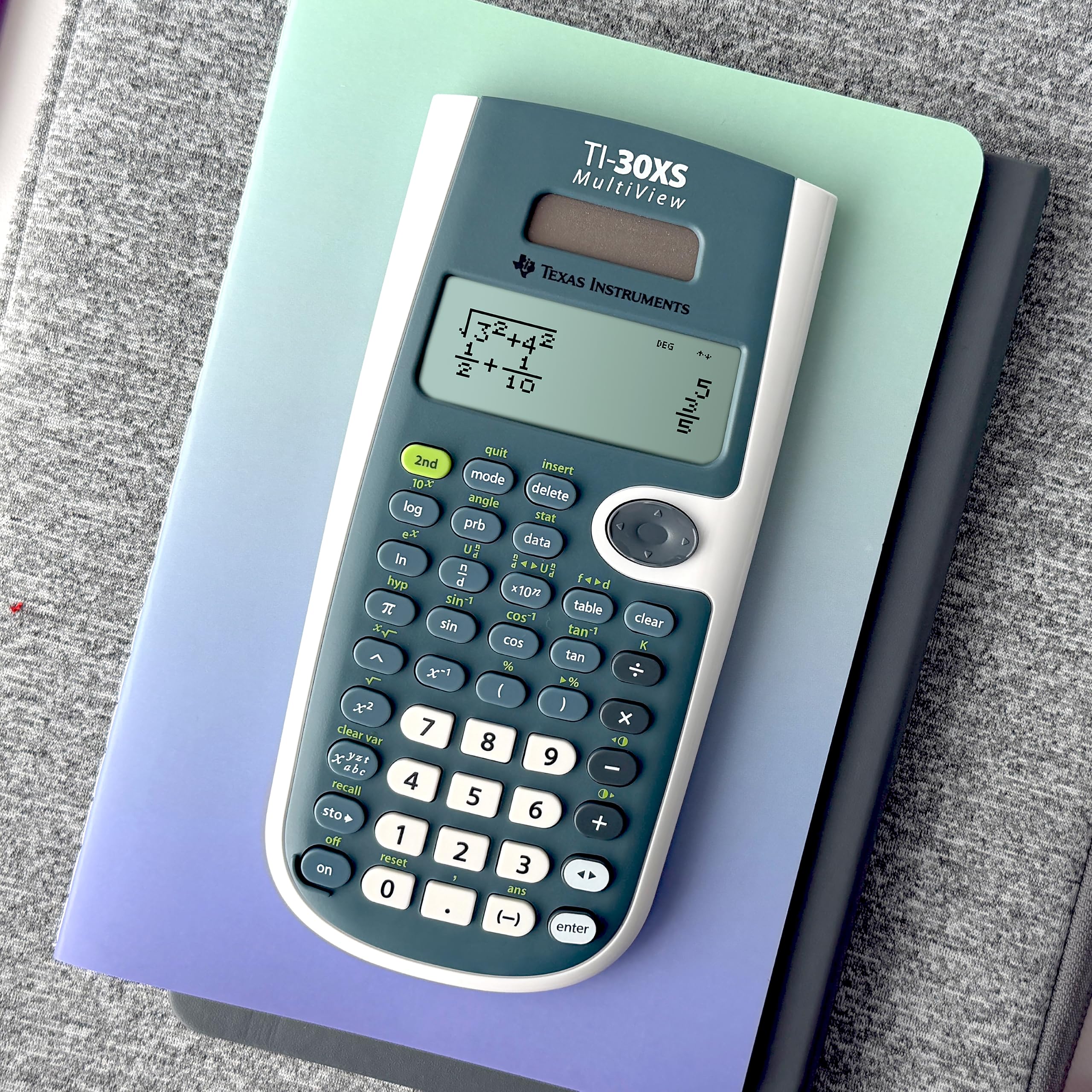 Texas Instruments TI-30XS next to a ruler showing compact size and classroom portability