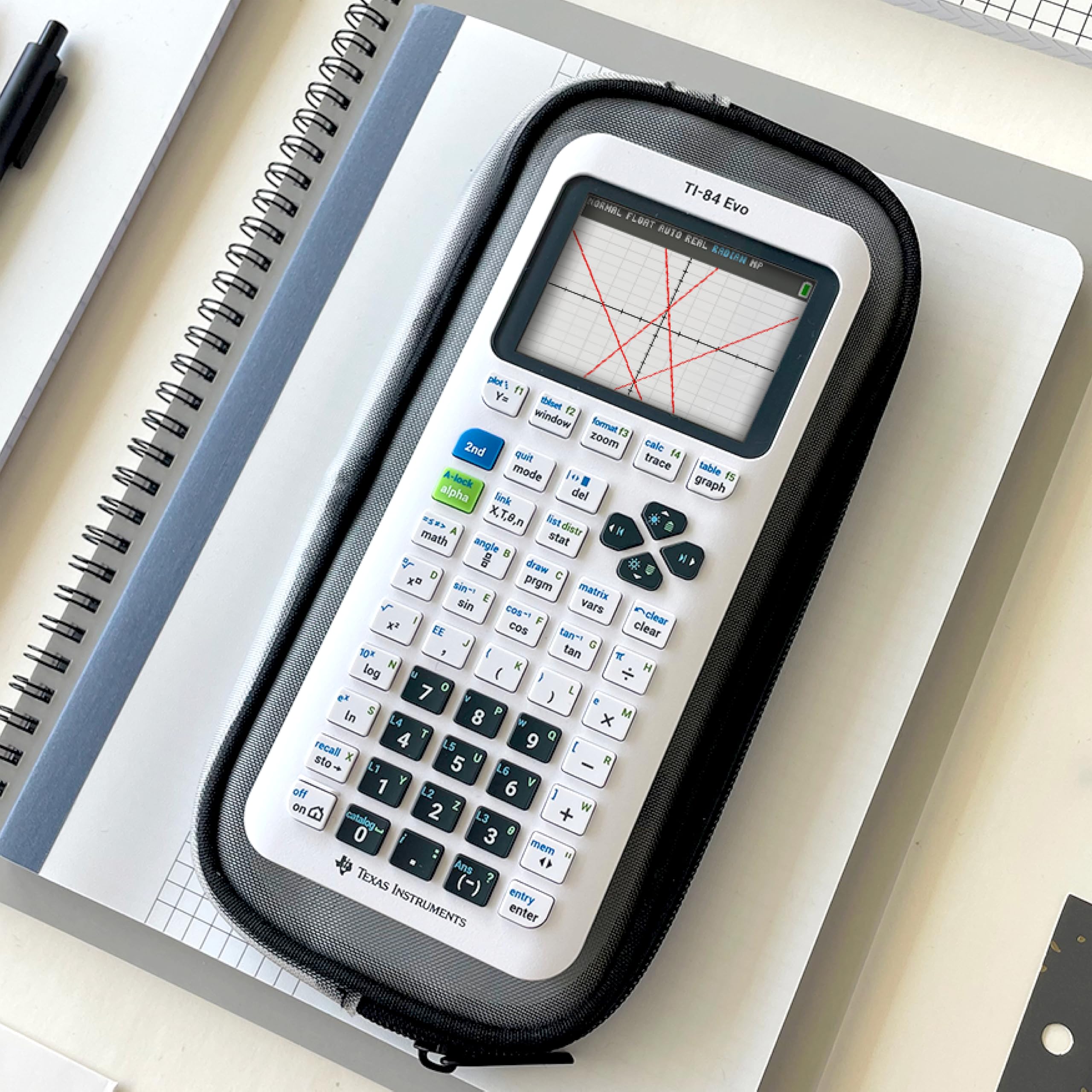 Texas Instruments TI-84 Evo beside notebook in study lifestyle scene for test preparation convenience