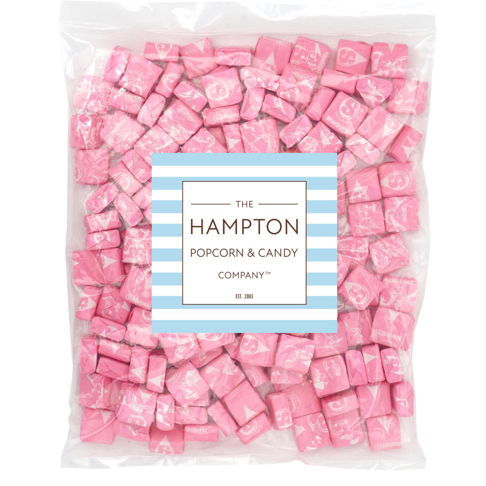 Close-up of individually wrapped Starburst All Pink pieces showing THE HAMPTON CANDY COMPANY freshness seal