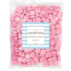 Close-up of individually wrapped Starburst All Pink pieces showing THE HAMPTON CANDY COMPANY freshness seal