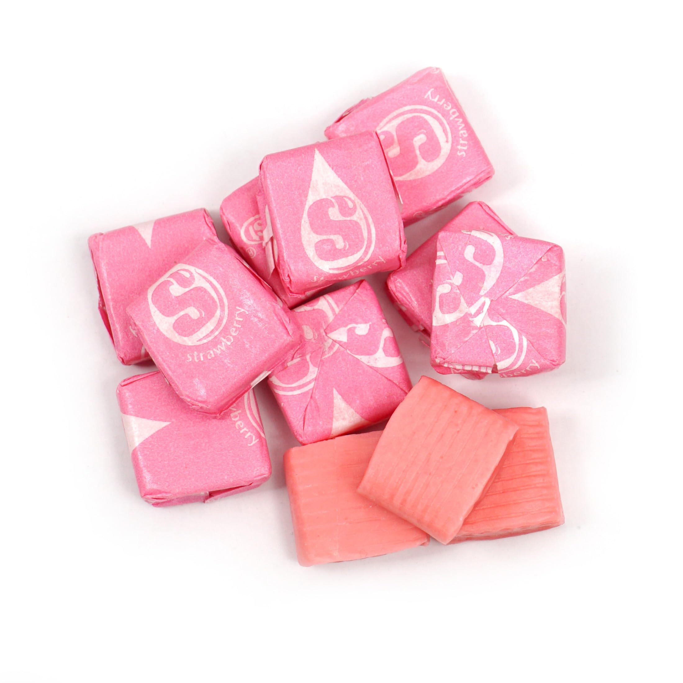 Scattered pink Starburst chews from THE HAMPTON CANDY COMPANY showing consistent strawberry color and texture