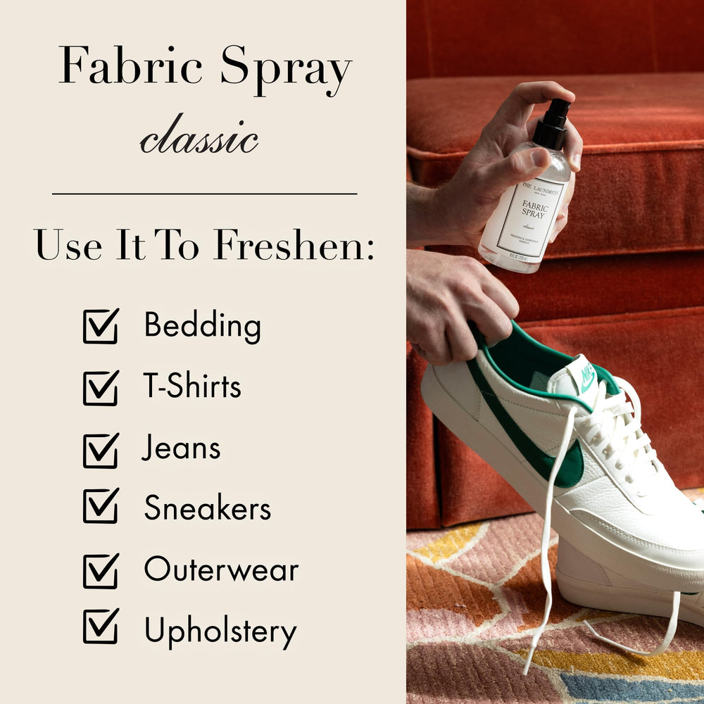 The Laundress 8 fl oz bottle next to common objects showing travel-friendly size convenience
