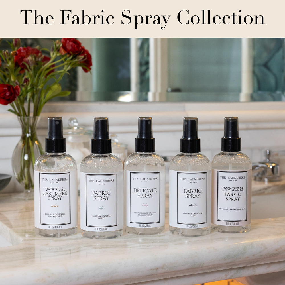 Styled cedar fragrance shot with The Laundress spray conveying warm, refined scent