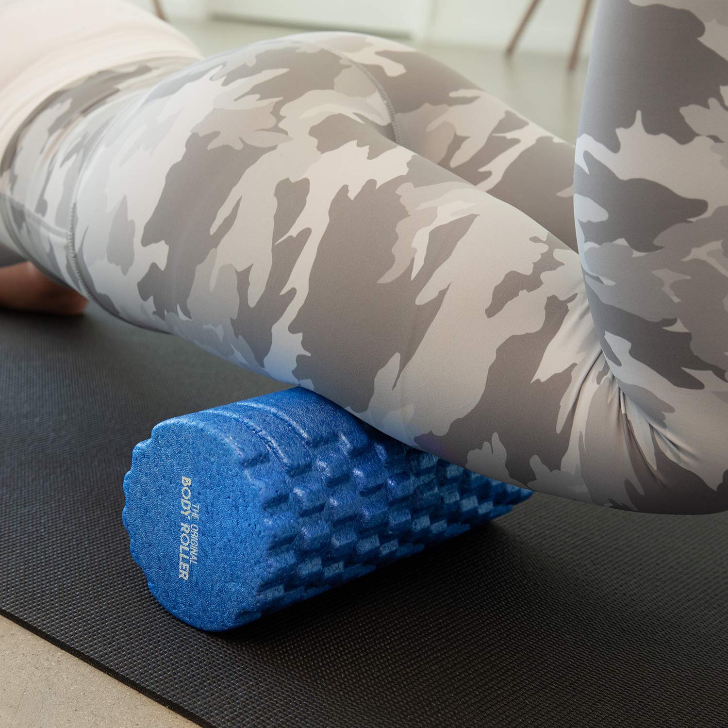The Original Body Roller on exercise mat in home gym setting showing convenient use benefit