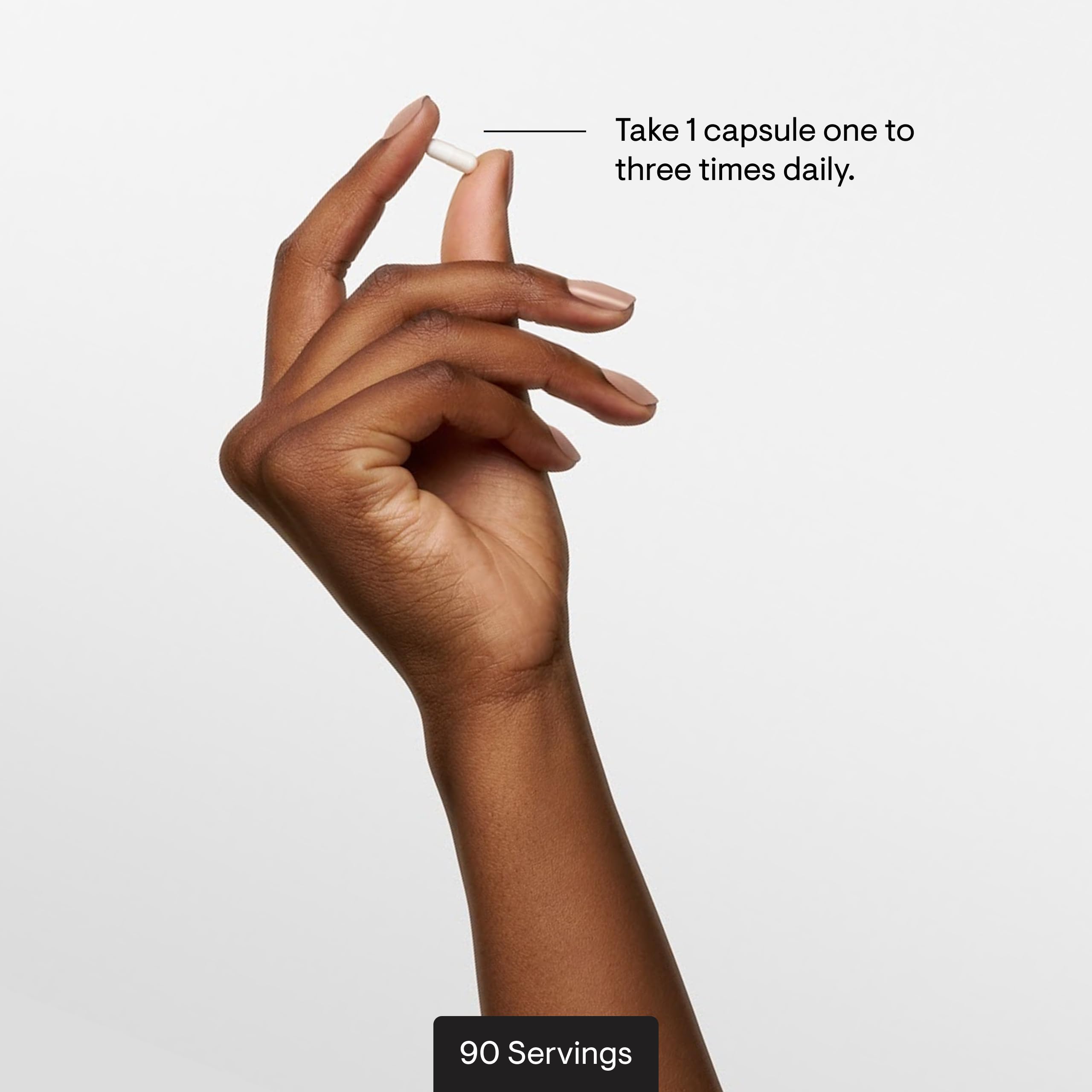 THORNE capsule in hand to demonstrate size and ease of daily intake for consumer perspective