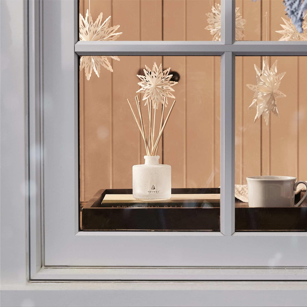 Thymes Frasier Fir diffuser in cozy entryway setting creates welcoming woodsy ambiance