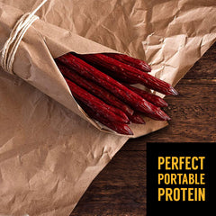Tillamook Country Smoker stick held in hand, demonstrates portable protein snack