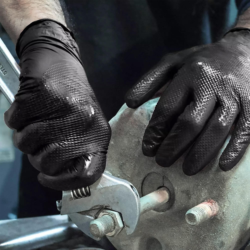 TitanFlex gloves in a garage workshop emphasizing heavy-duty durability