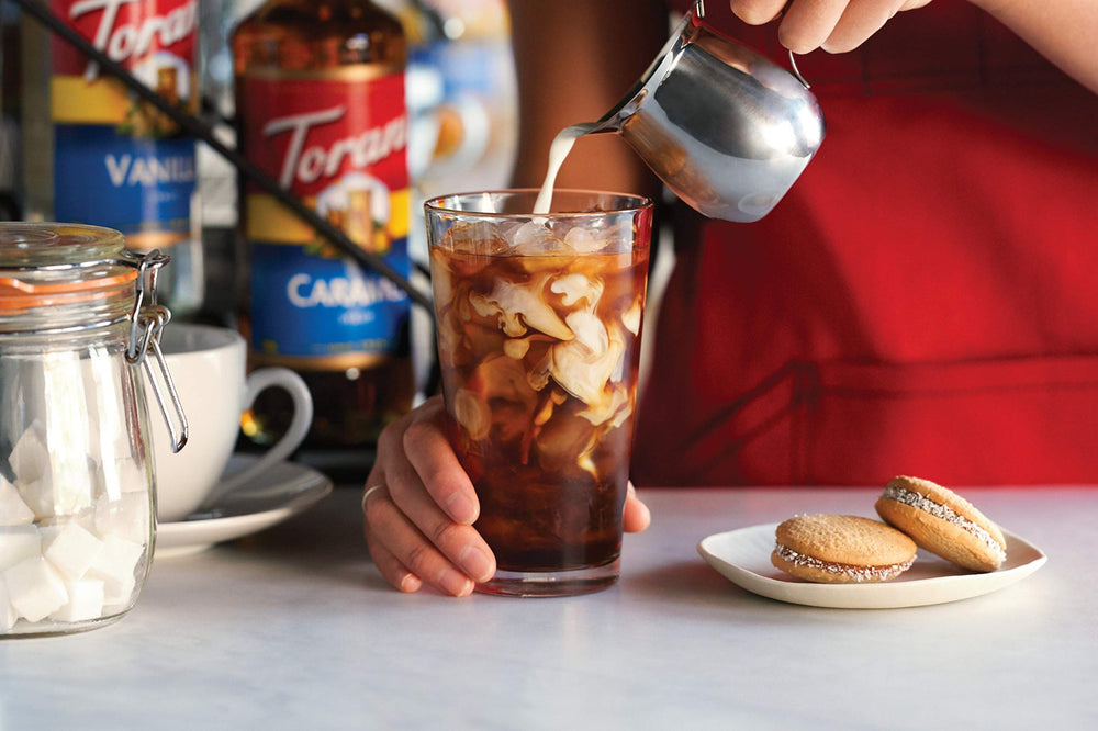 Torani sugar free vanilla creating a sparkling Italian soda showcasing refreshing sugar-free option