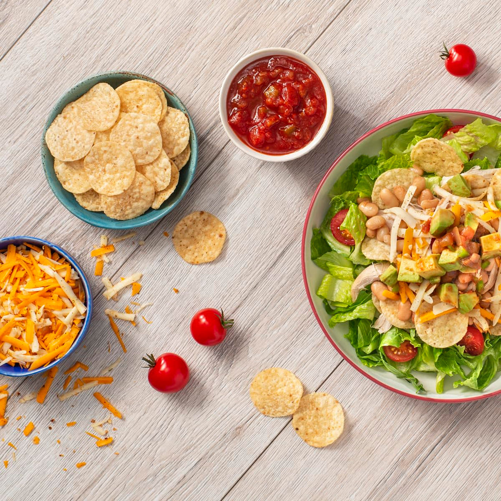 Tostitos pack next to soda can for scale, demonstrates compact portion size