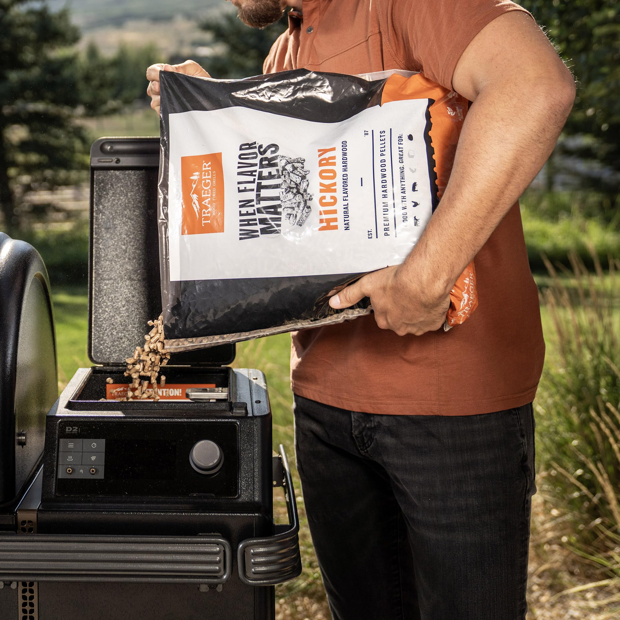 Traeger pellets feeding into a grill burn pot demonstrating steady burn performance