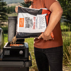 Traeger grill in use emitting smoke showing enhanced flavor benefit for meals