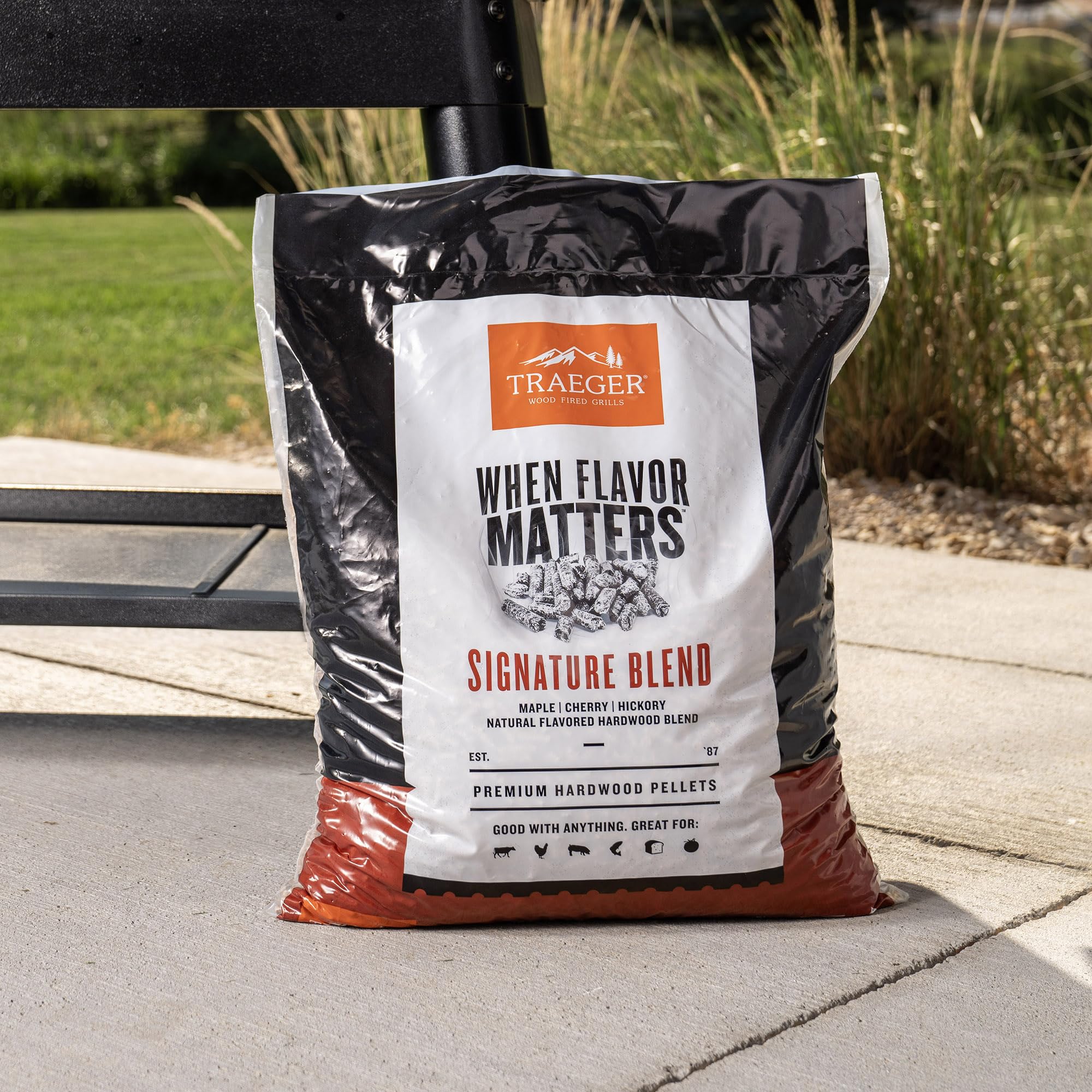 Traeger pellets being loaded into a grill hopper demonstrating easy feed reliability
